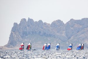 Sailboats on water displaying country flags 